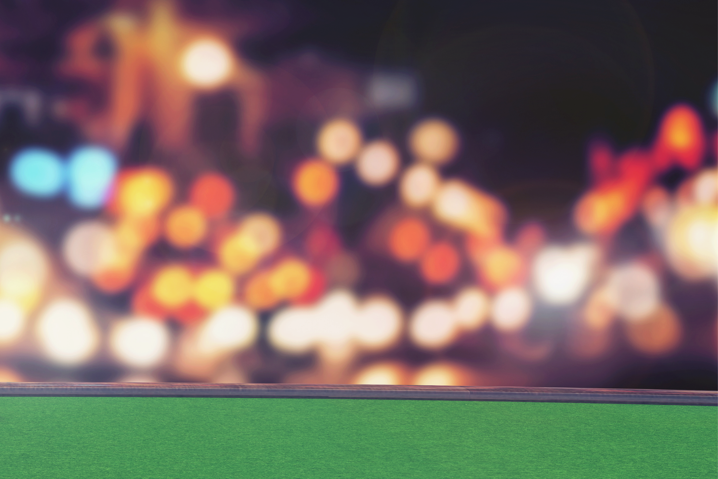 the soft glow of casino lights behind a green felt