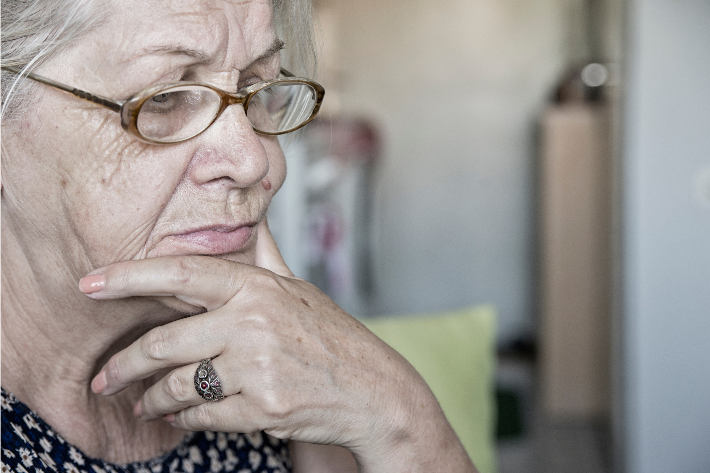 a close-up of an older woman contemplates something