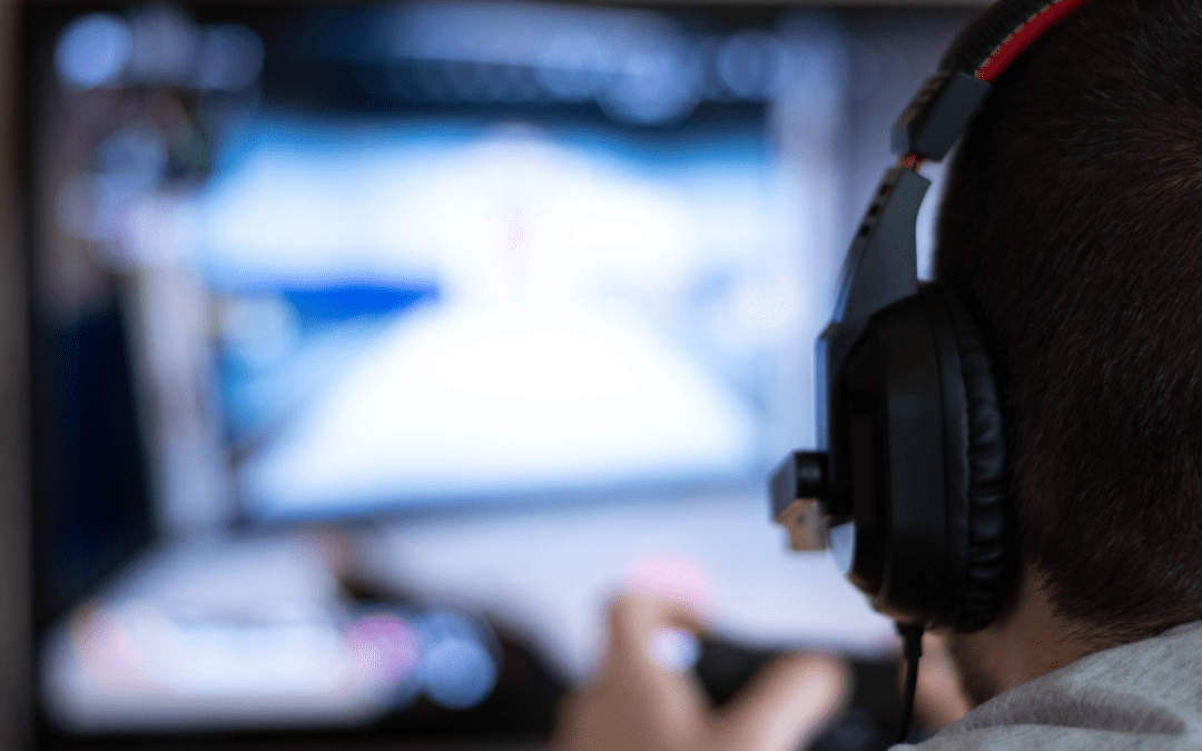 a young person in a headset plays a nondescript video game